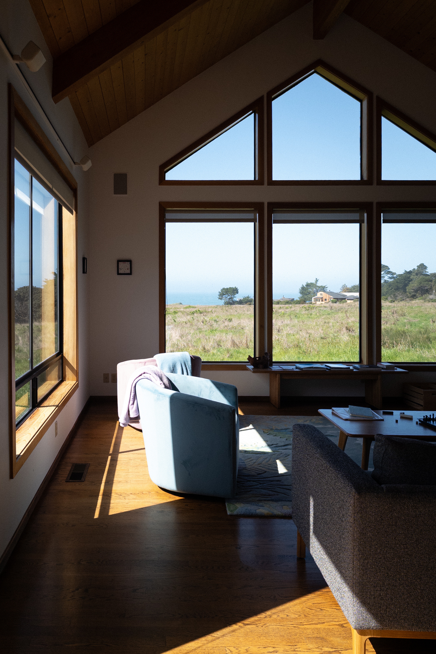 View of open plain leading to Pacific Ocean through living room windows